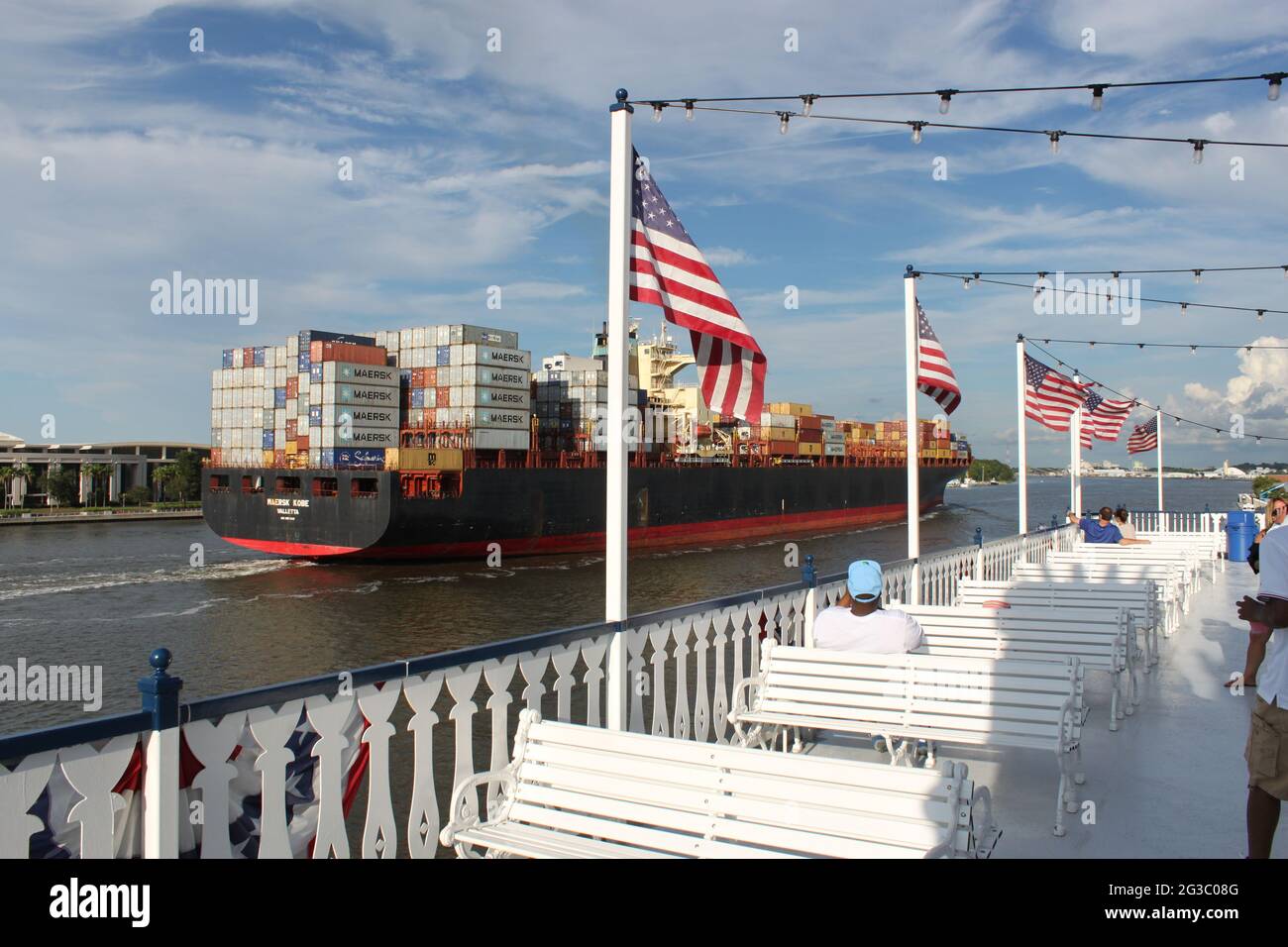 Massive carge ship passing a Paddlesteamer on the Savannah River USA Stock Photo