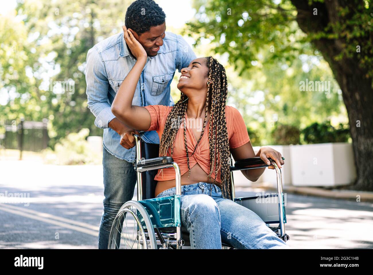 Woman in a wheelchair enjoying a walk with her boyfriend Stock Photo ...