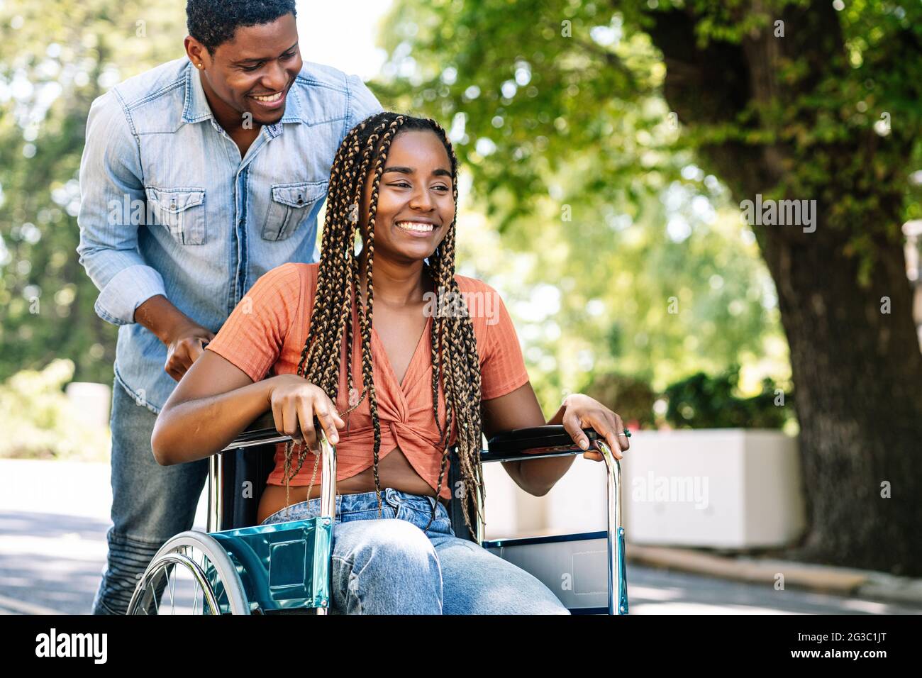 Woman in a wheelchair enjoying a walk with her boyfriend Stock Photo ...