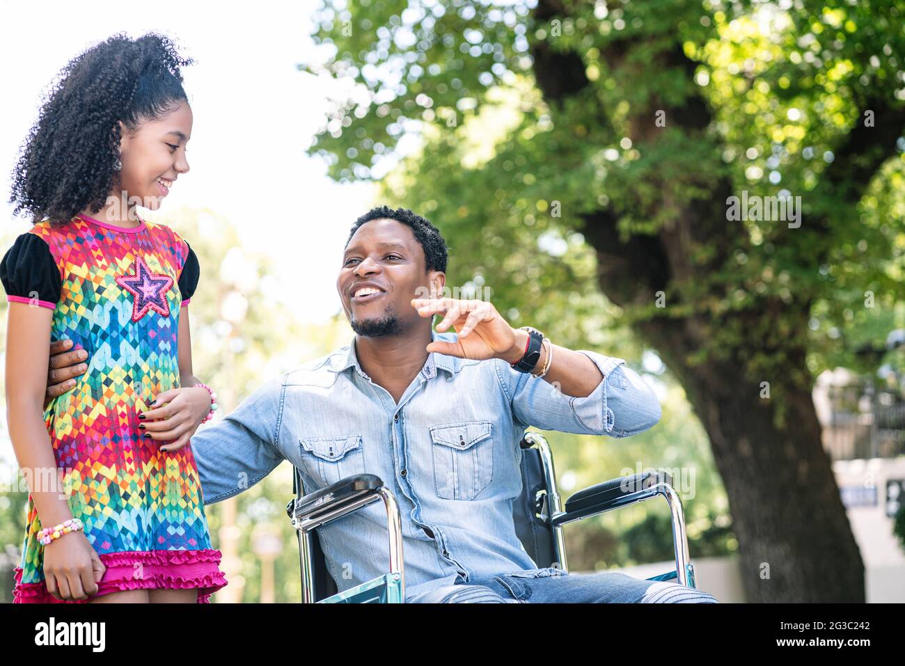 Man in a wheelchair enjoying a walk with his daughter Stock Photo - Alamy
