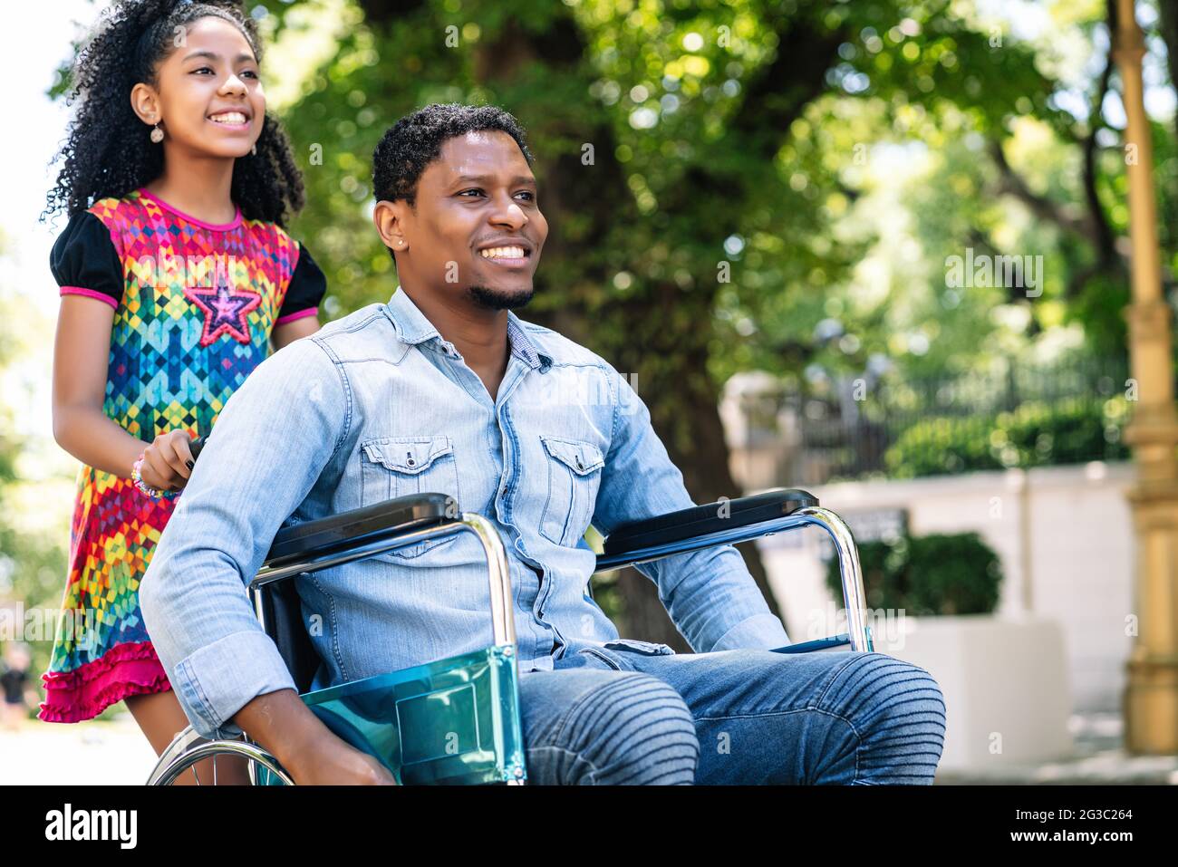 Man in a wheelchair enjoying a walk with his daughter Stock Photo - Alamy