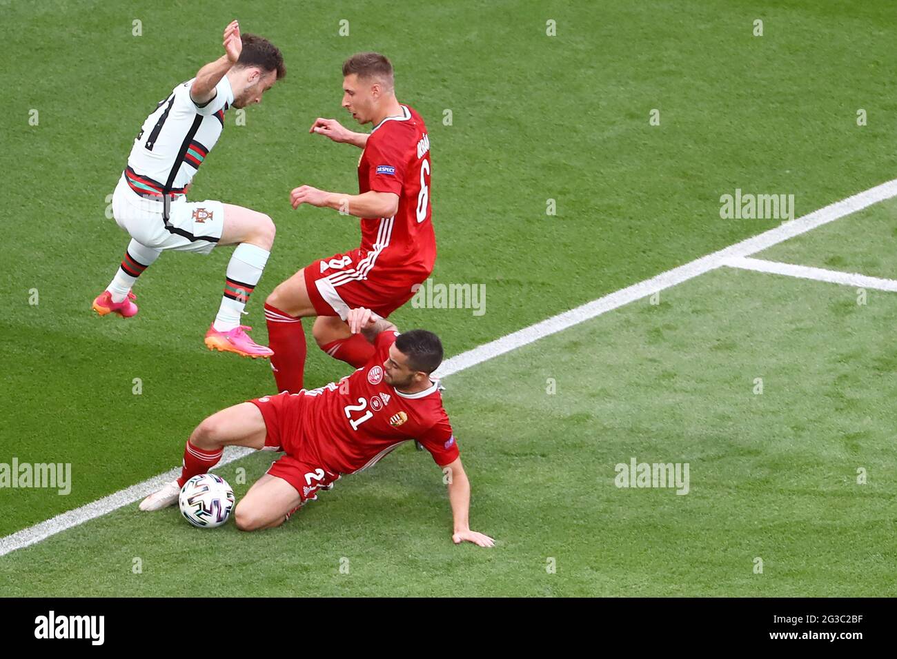 BUDAPEST, HUNGARY - JUNE 15: Portuguese player Dioga Jota (21) fights for the ball with two Hungarian players Willi Orbán (6) and Endre Botka (21) during the match at the UEFA Euro 2020 Championship Group F match between Hungary and Portugal on June 15, 2021 in Budapest, Hungary. (Photo by MB Media) Stock Photo