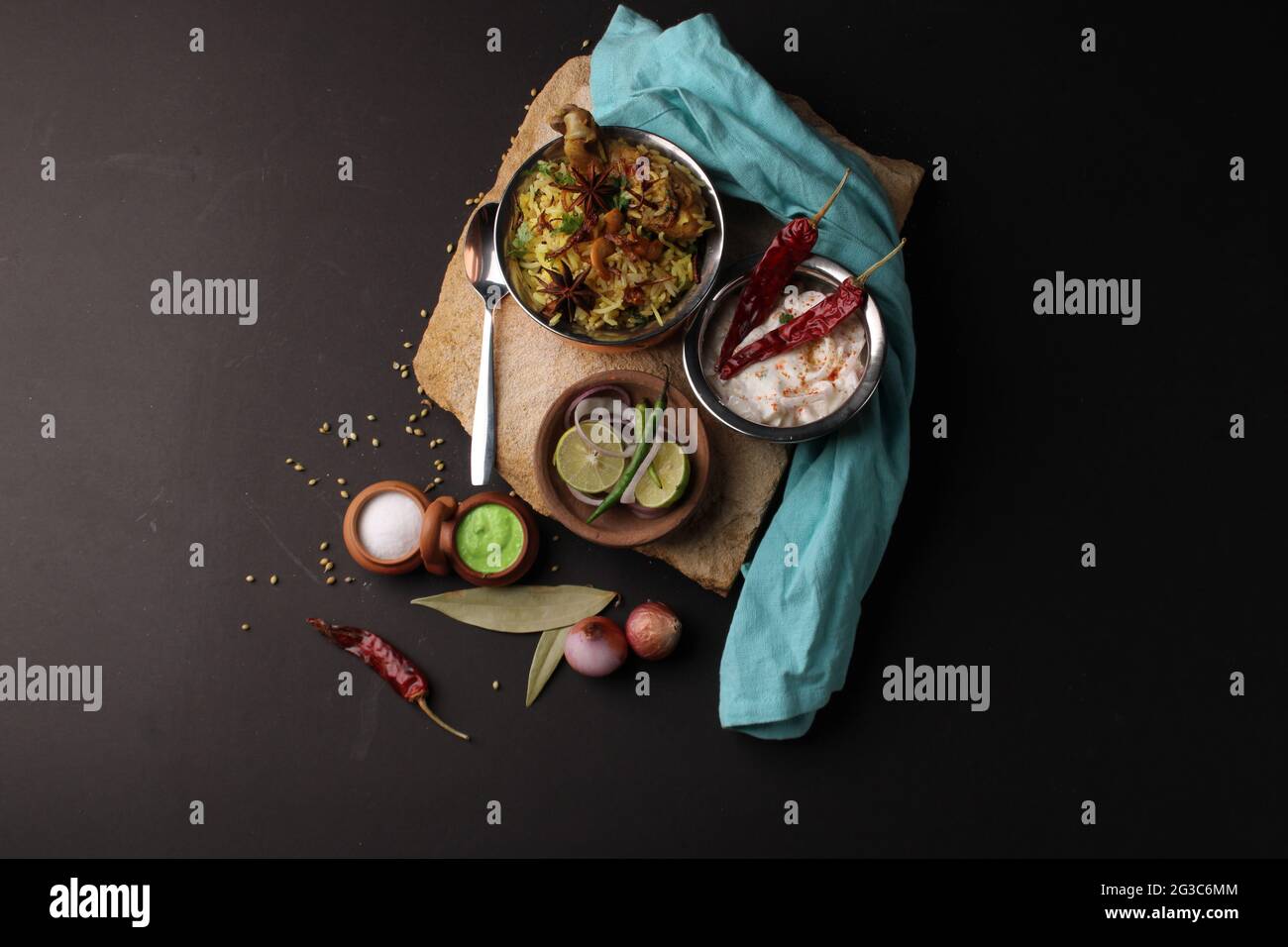 Dum Raita Spicy chicken dum biryani in traditional handi or clay pot. served with ...