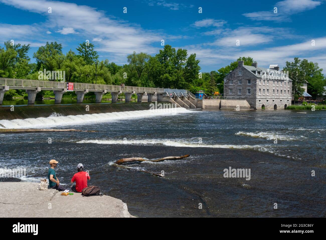Terrebonne, Quebec, Canada - 11 June 2021: The Moulin neuf (New Mill) and Moulin-Neuf dam at the Île-des-moulins Stock Photo