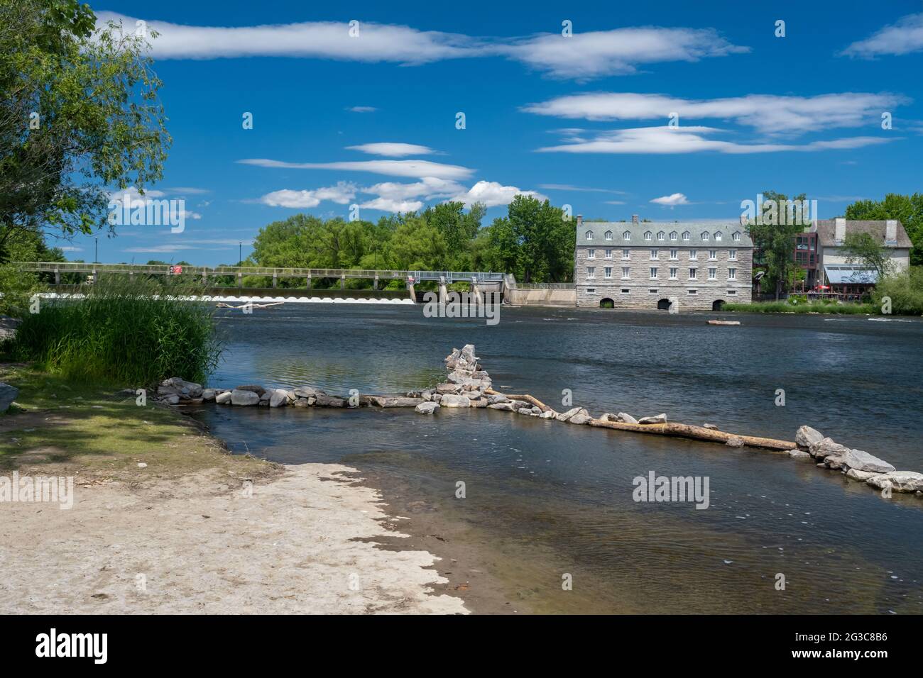 Terrebonne, Quebec, Canada - 11 June 2021: The Moulin neuf (New Mill) and Moulin-Neuf dam at the Île-des-moulins Stock Photo