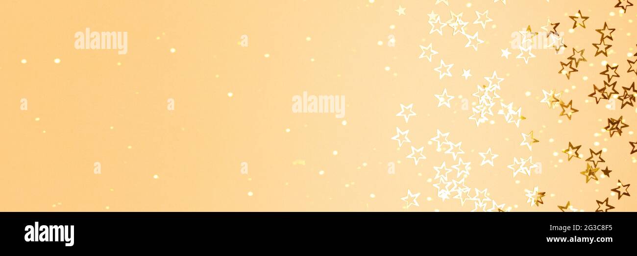Banner with glowing stars confetti on a gold background with copy space ...