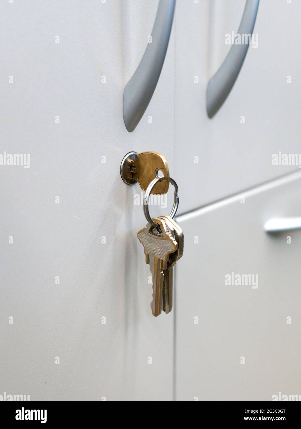 Close up focused on Keys in an office cabinets lock Stock Photo