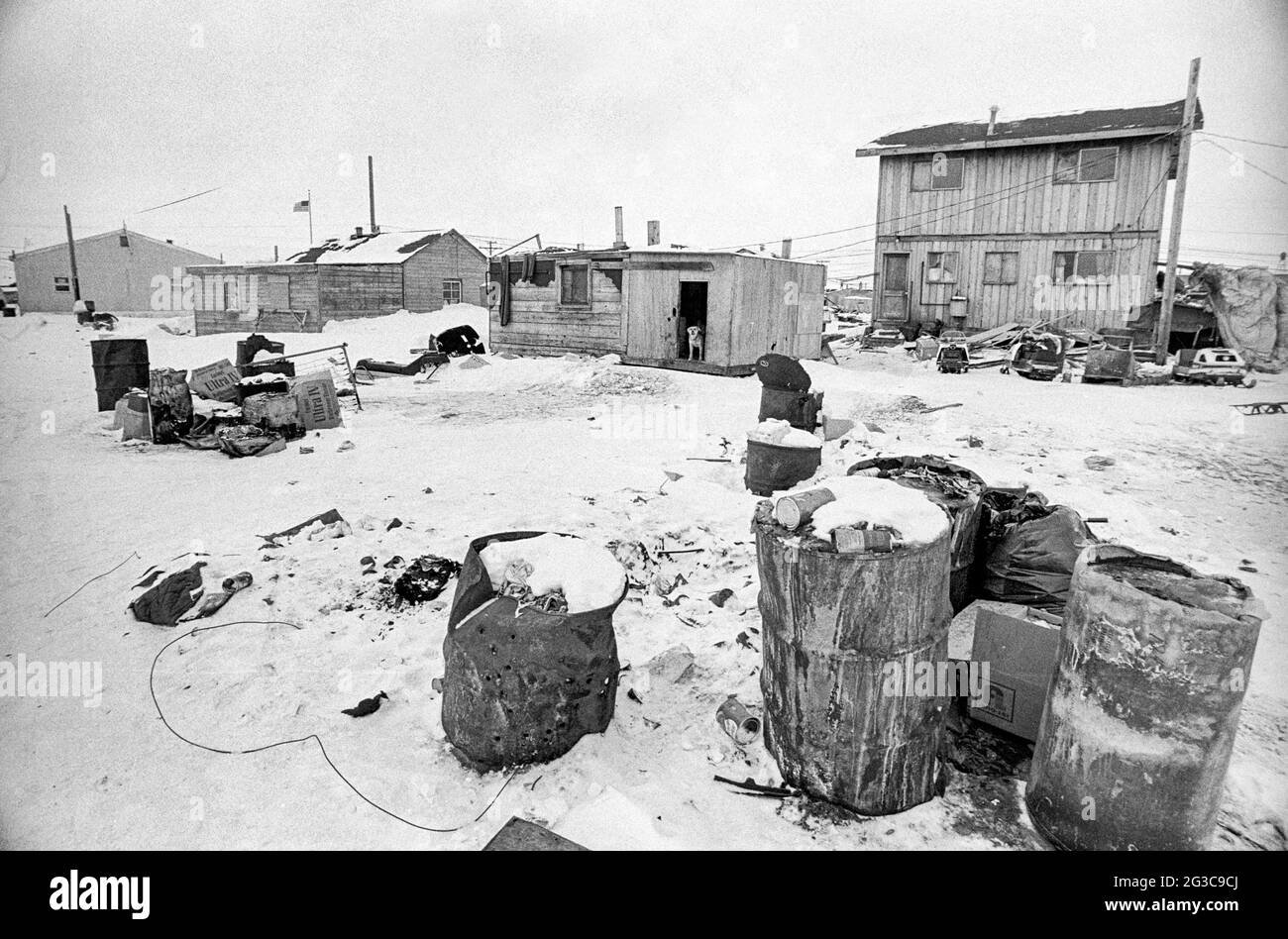 Frozen garbage cans are neglected in winter snow in Barrow, Alaska