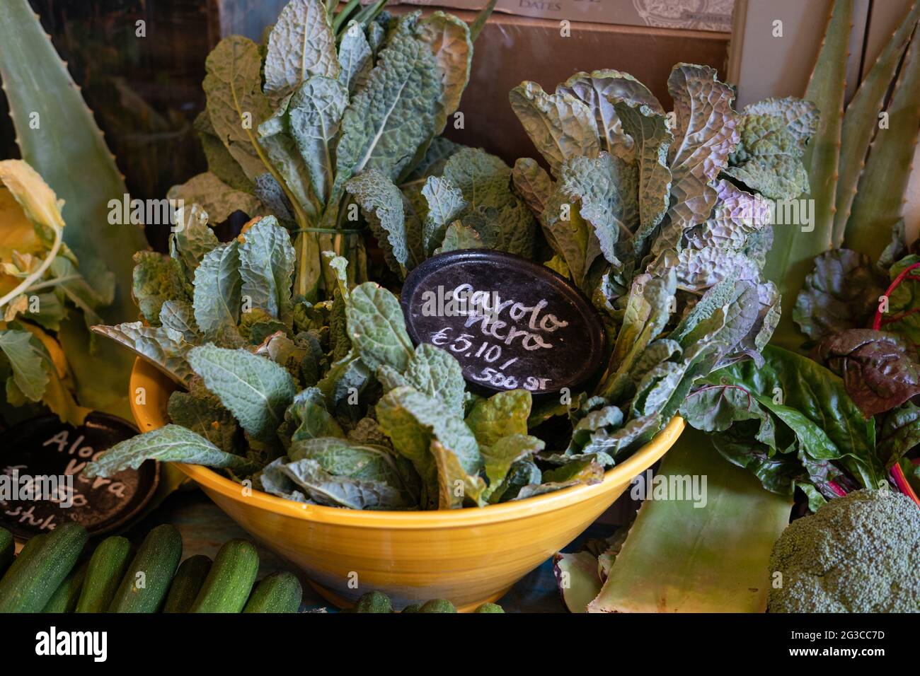 A variety of fresh vegetables displayed in a bowl with cavolo nero or Tuscan kale or black kale Stock Photo