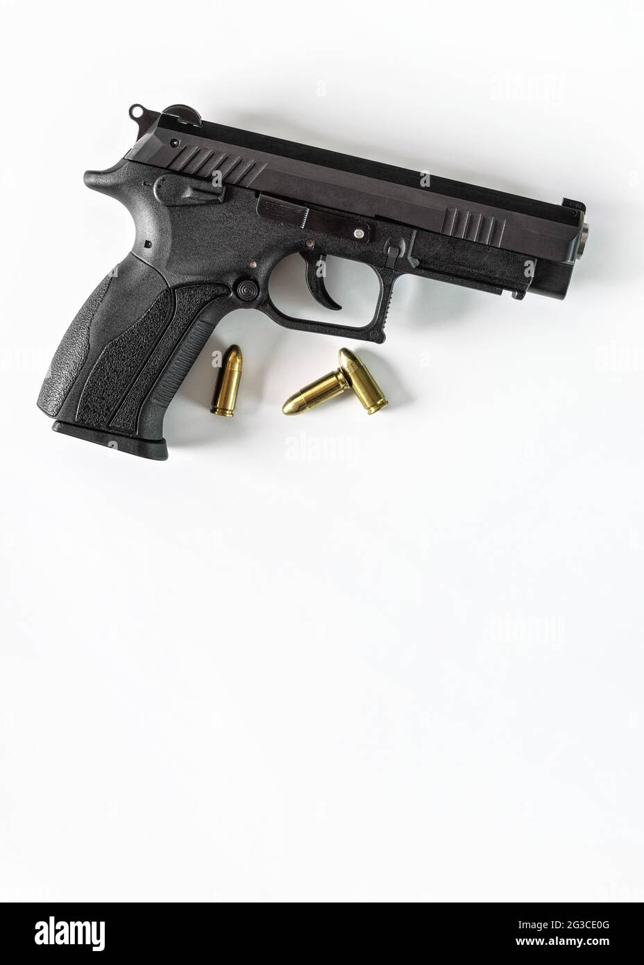 Modern black metal gun with  three bullets, white space for text below Stock Photo