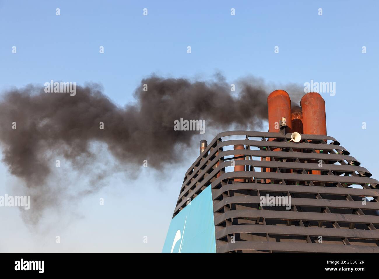 Chimney of a ferry spewing black smoke as the boat departs. Marseille ...