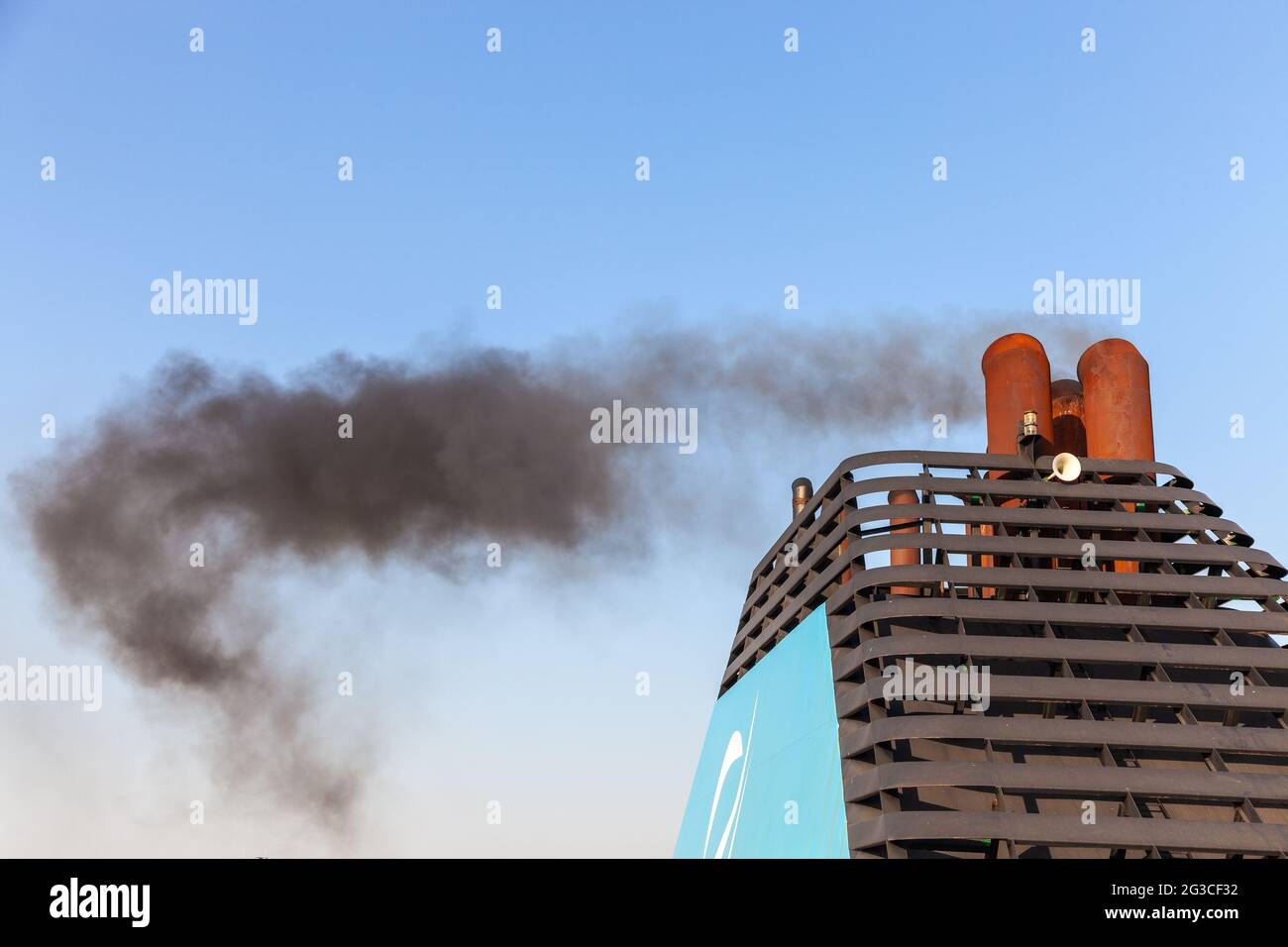 Chimney of a ferry spewing black smoke as the boat departs. Marseille ...