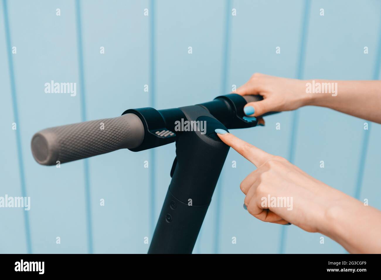Woman turning on or off the electric scooter in street Stock Photo Alamy