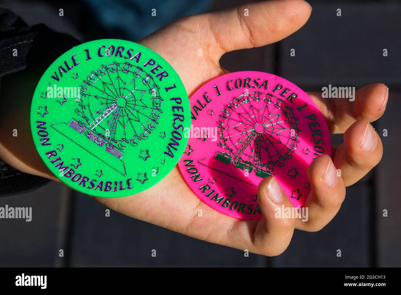 Tickets for the ferris-wheel in Sopron, Hungary. Italian text on plastic disks: Valid for 1 ride per 1 person. Non refundable. Stock Photo