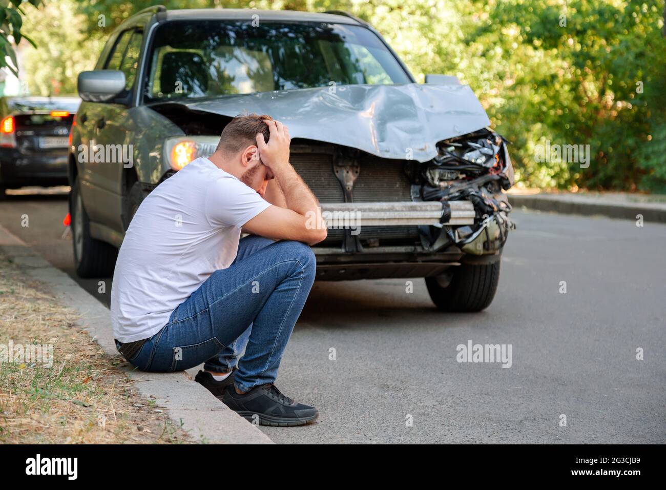 Car accident. Man holding his head after car accident. Man regrets ...