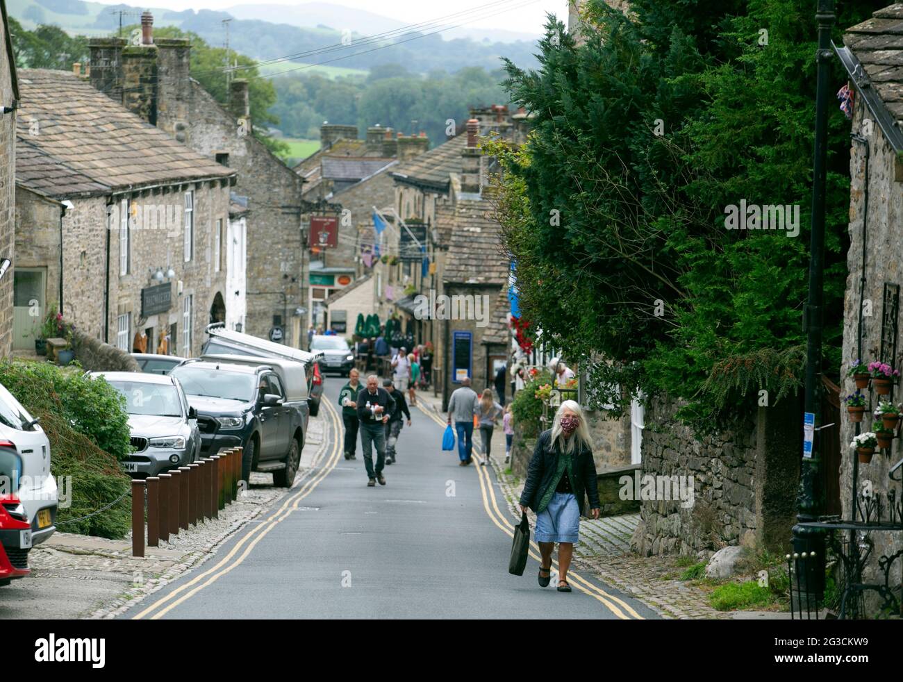 People walk up the streets of Grassington in the Yorkshire Dales. The town has recently been used to film the new series of the classic TV series All Stock Photo