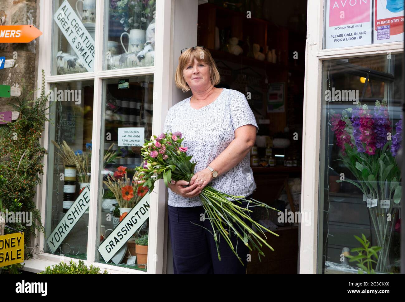 Julia Metcalfe (56) photographed in her shop The Flower Loft in Grassington in the Yorkshire Dales. The town has recently been used to film the new se Stock Photo