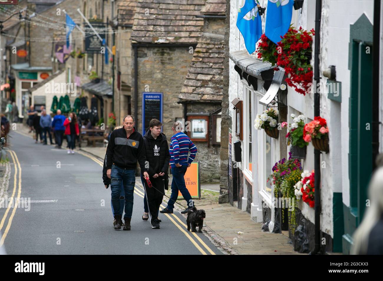 People walk up the streets of Grassington in the Yorkshire Dales. The town has recently been used to film the new series of the classic TV series All Stock Photo