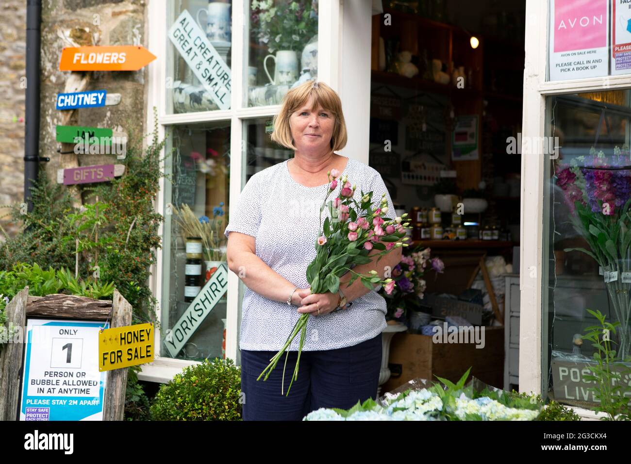 Julia Metcalfe (56) outside her shop The Flower Loft in Grassington in the Yorkshire Dales. The town has recently been used to film the new series of Stock Photo