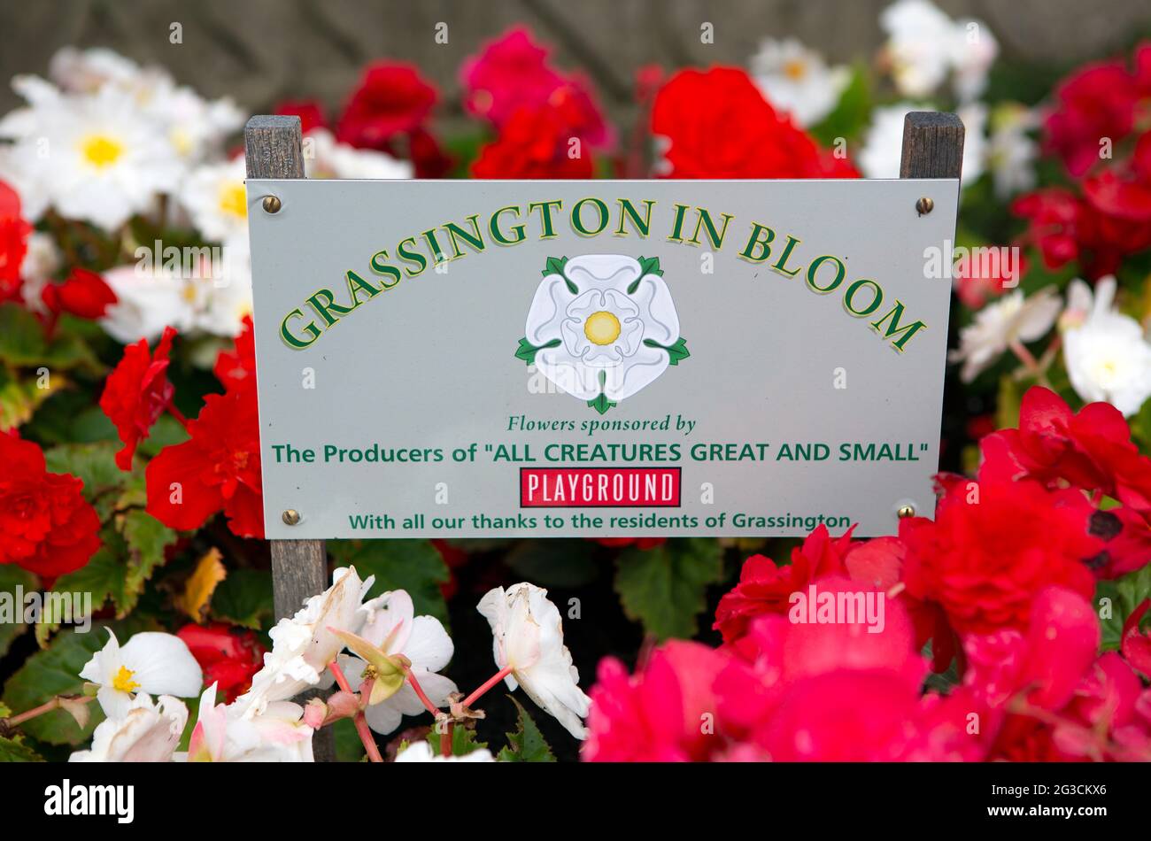 A flowerbed sign in Grassington in the Yorkshire Dales. The town has recently been used to film the new series of the classic TV series All Creatures Stock Photo