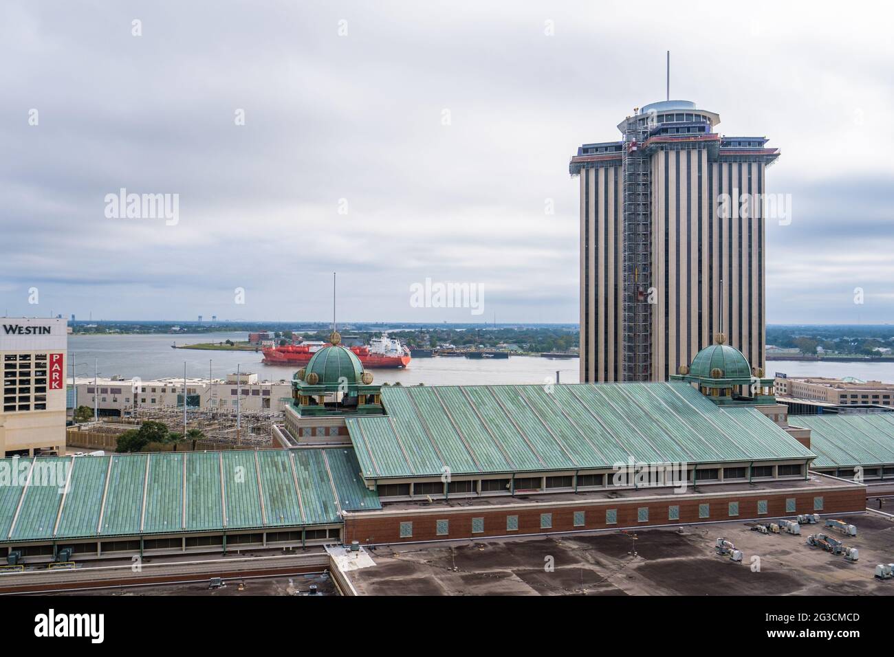NEW ORLEANS, LA - OCTOBER 27, 2020: International Trade Mart Building, Roof of Harrah's Casino and Crescent of Mississippi River with Freighter Stock Photo