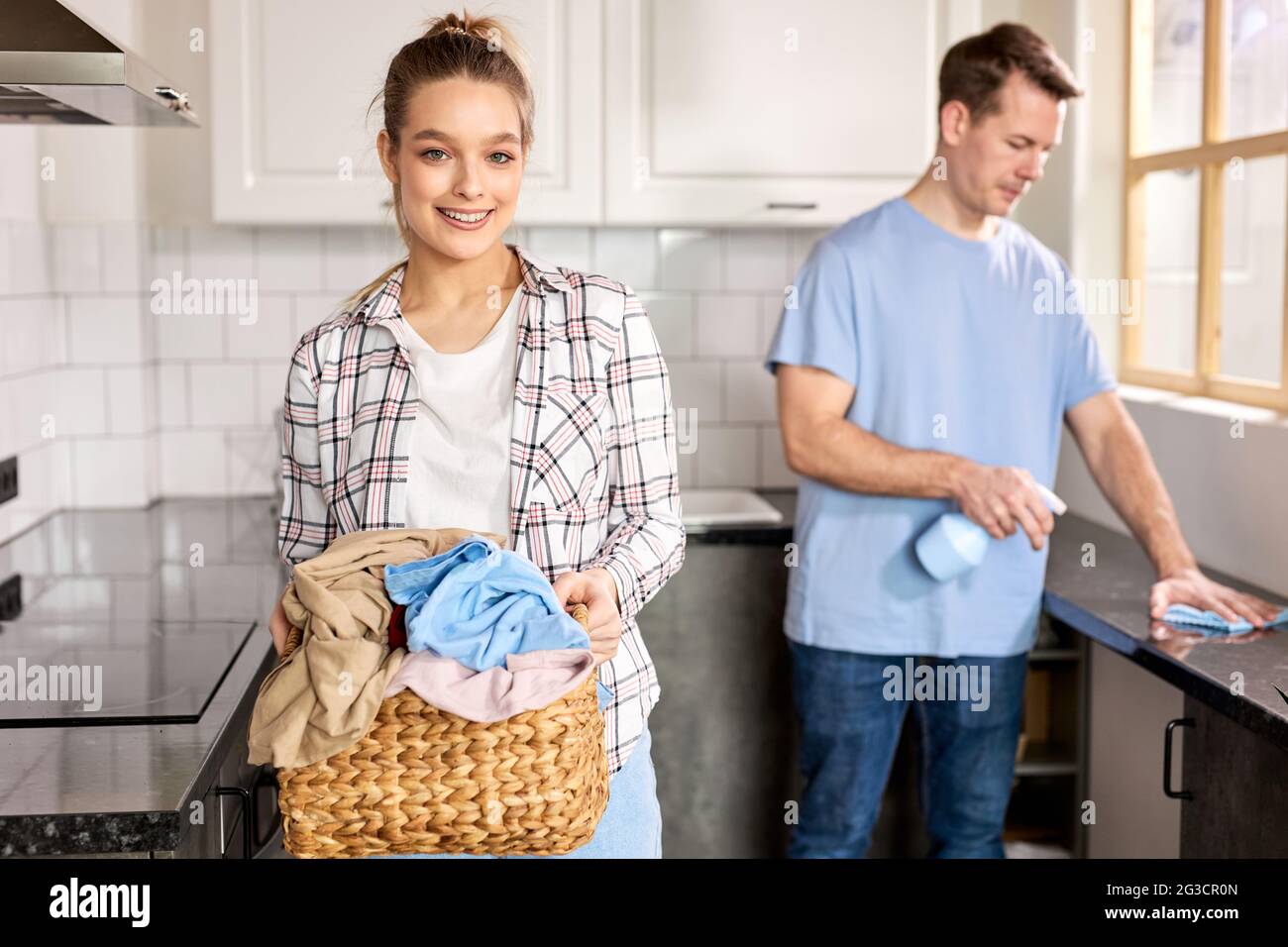 Man husband cleaning the house helping wife Stock Photo - Alamy