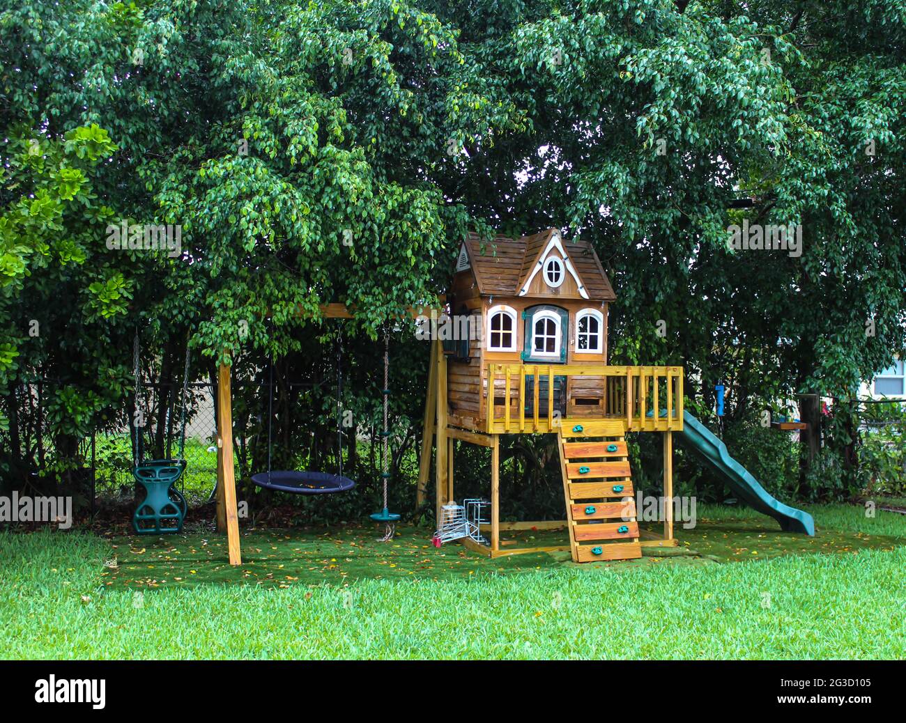 Backyard wooden swing set for kids to play. Summer time activity Stock Photo