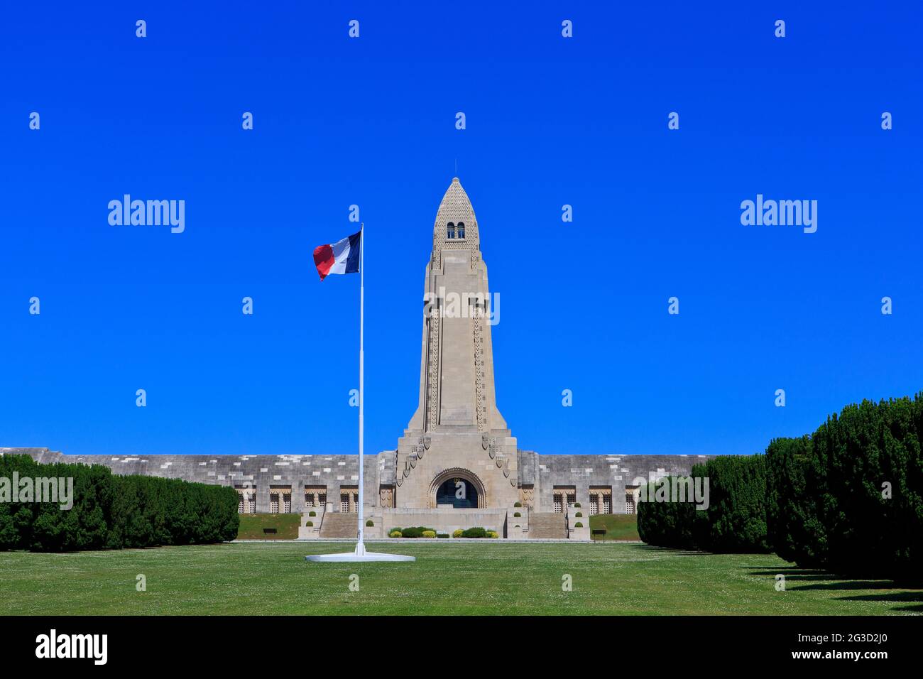 The French flag flying proudly over the WWI Douaumont Ossuary & Fleury-devant-Douaumont National Necropolis in Douaumont-Vaux (Meuse), France Stock Photo