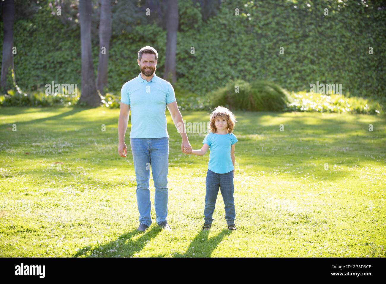 father and son walking in park. happy family value. childhood and parenthood. Stock Photo