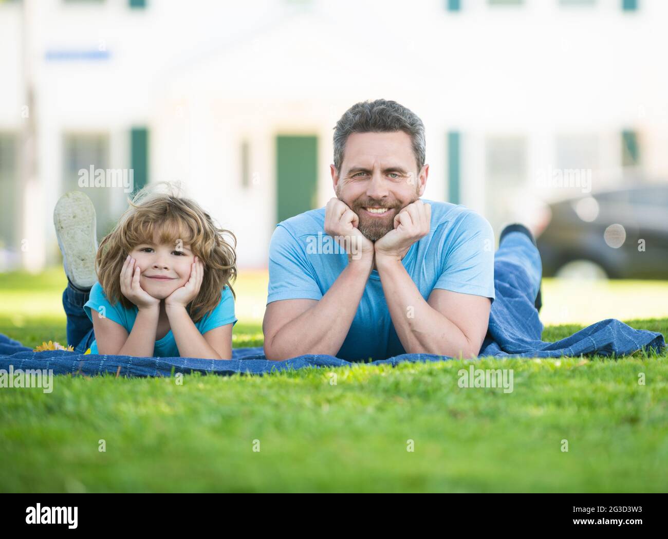 Happy family resting on grass hi-res stock photography and images - Alamy