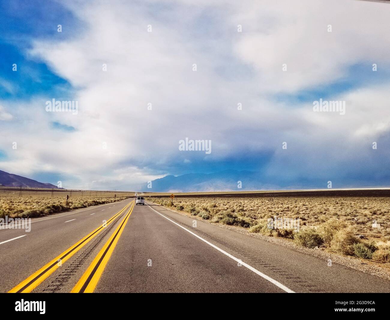 Dramatic view of road with cloudy and smokey sky from nearby fires Stock Photo