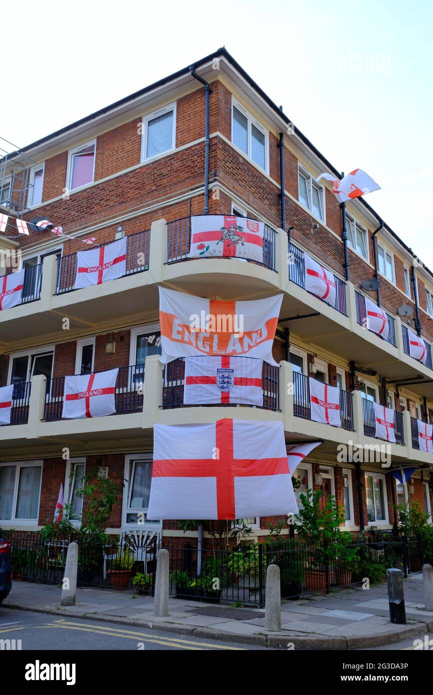 London, UK. Over 400 St George's flags line the balconies on Kirby Estate where residents decorated buildings in advance of the Euro 2020 tournament Stock Photo