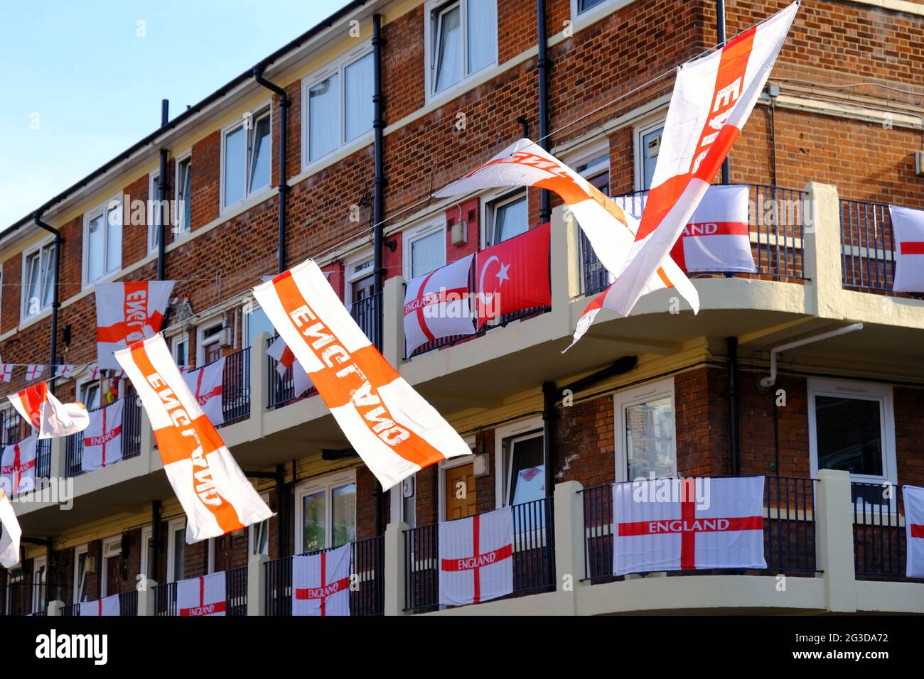 London, UK. A Turkish flag sits amongst St George's flags as Kirby Estate residents in Bermonsdey decorate balconies for Euro 2020. Stock Photo
