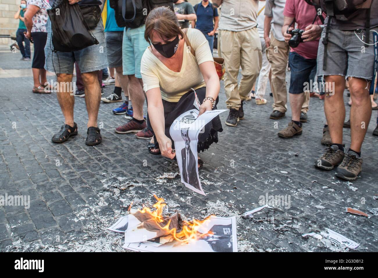 Elisenda Paluzie, president of the Catalan National Assembly (ANC), is seen burning photos of the Spanish king, Felipe VI, during the demonstration.The Catalan association that aims at achieving the political independence of Catalonia, the Catalan National Assembly (ANC), has called a demonstration against the visit to Catalonia of the Spanish King, Felipe VI, to attend the inaugural dinner of the XXXVI Meeting of the Barcelona business organization, Circulo de Economia (Economy Circle). The demonstration was attended by the president of the ANC, Elisenda Paluzie, who participated in the burni Stock Photo