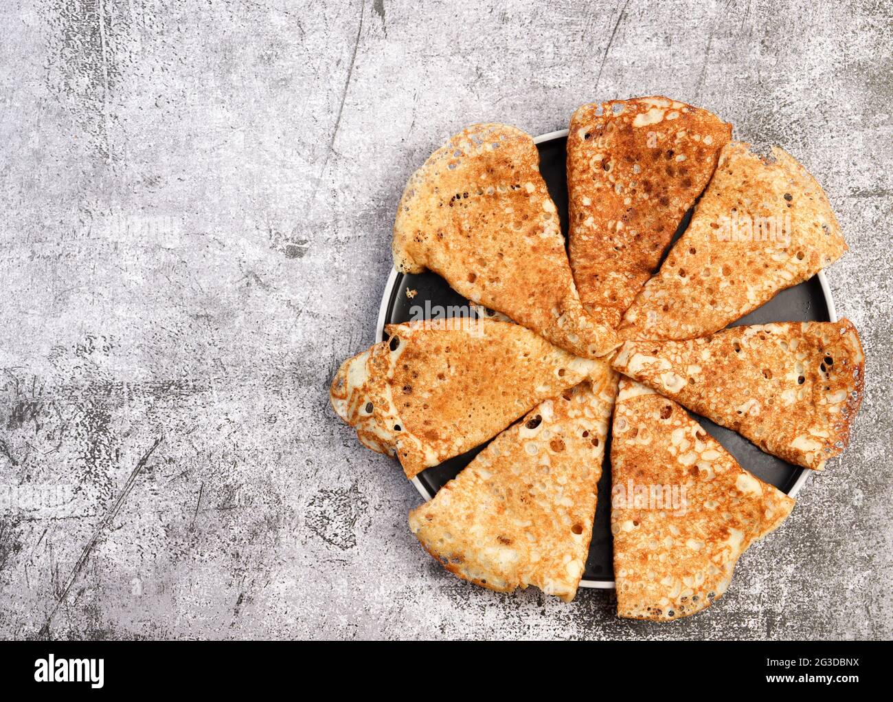 Crepes - traditional russian pancakes on a round plate on a dark ...