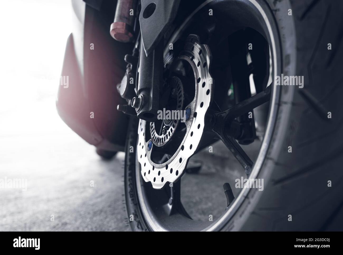 Closeup disc brake of a scooter. Aluminum alloy wheel of motorcycle