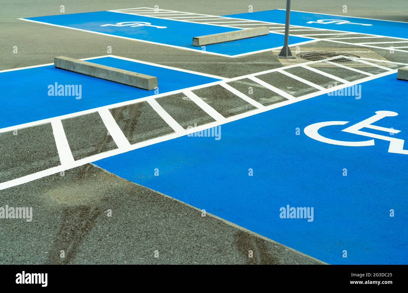 Asphalt car parking lot reserved for handicapped driver in supermarket or shopping mall. Car parking space for disabled people. Wheelchair sign paint Stock Photo