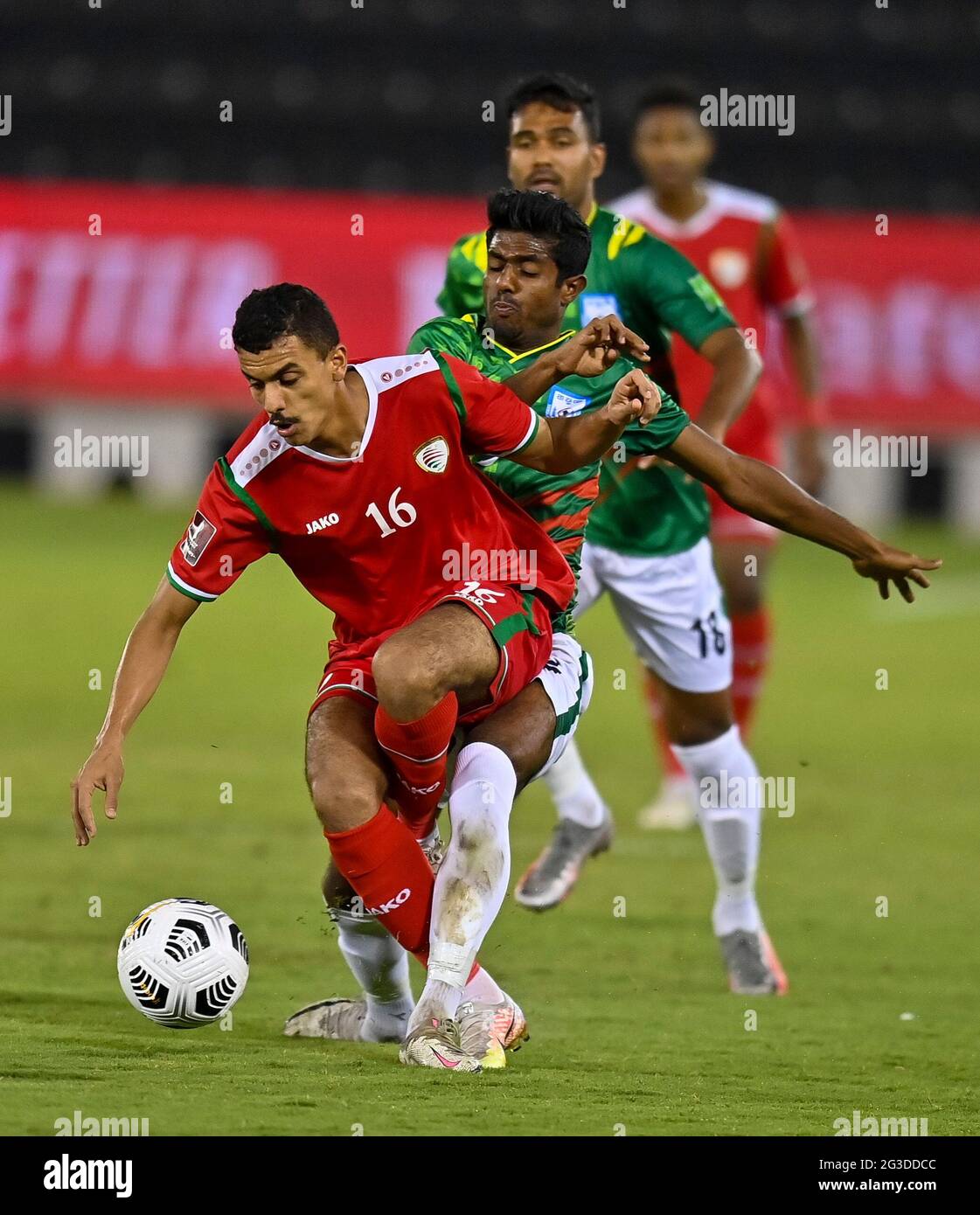 Doha, Qatar. 15th June, 2021. Mohammed Mubarak Al Ghafri (L) of Oman vies with Md Rimon Hossain of Bangladesh during the Group E football match at FIFA World Cup Qatar 2022 and AFC Asian Cup China 2023 Preliminary Joint Qualification in Doha, Qatar, June 15, 2021. Credit: Nikku/Xinhua/Alamy Live News Stock Photo