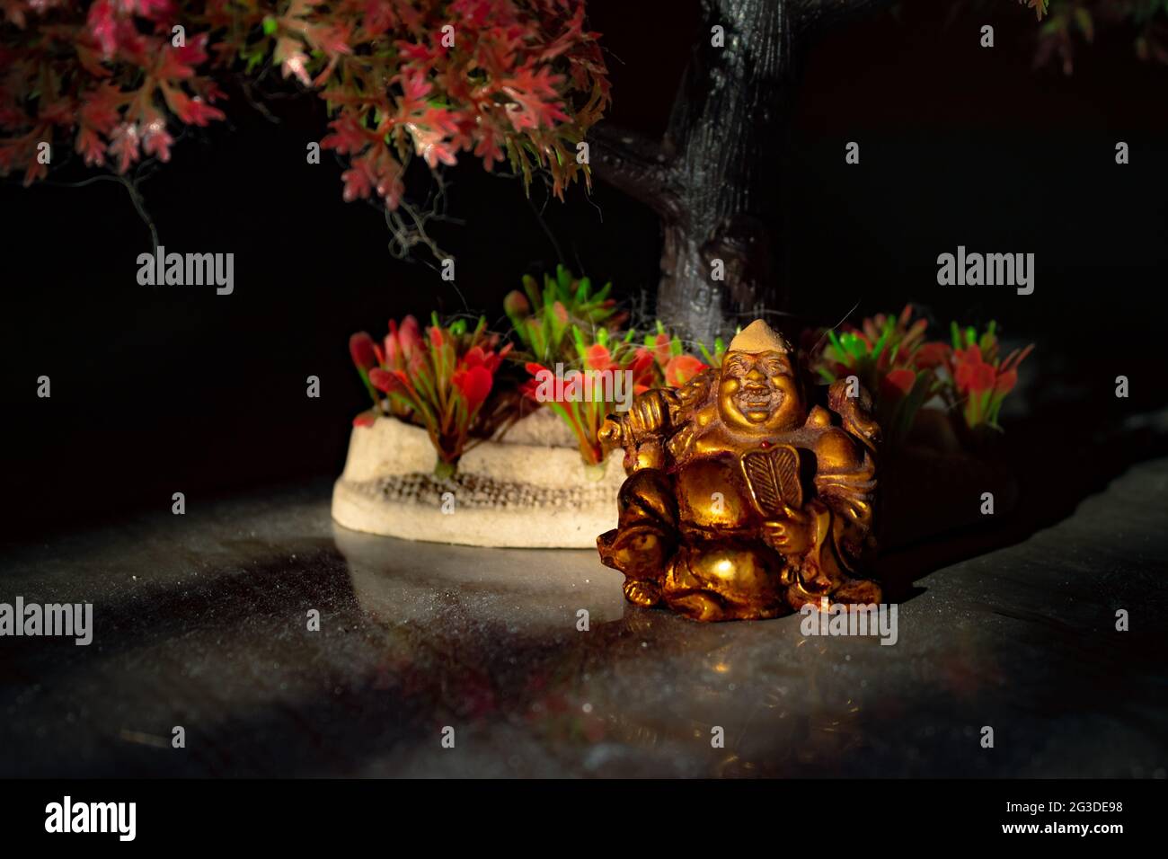 Laughing Buddha Statue on under the Tree. Statue of Laughing Buddha. Statue of kubera. Stock Photo