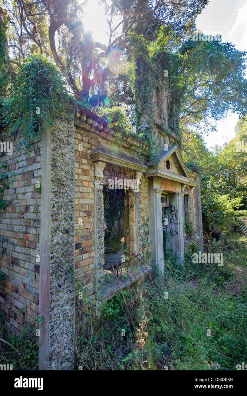 The crumbling remains of a small but ornate building (possibly a cottage) close to the water on the Gladesville Hospital site in Sydney, Australia Stock Photo
