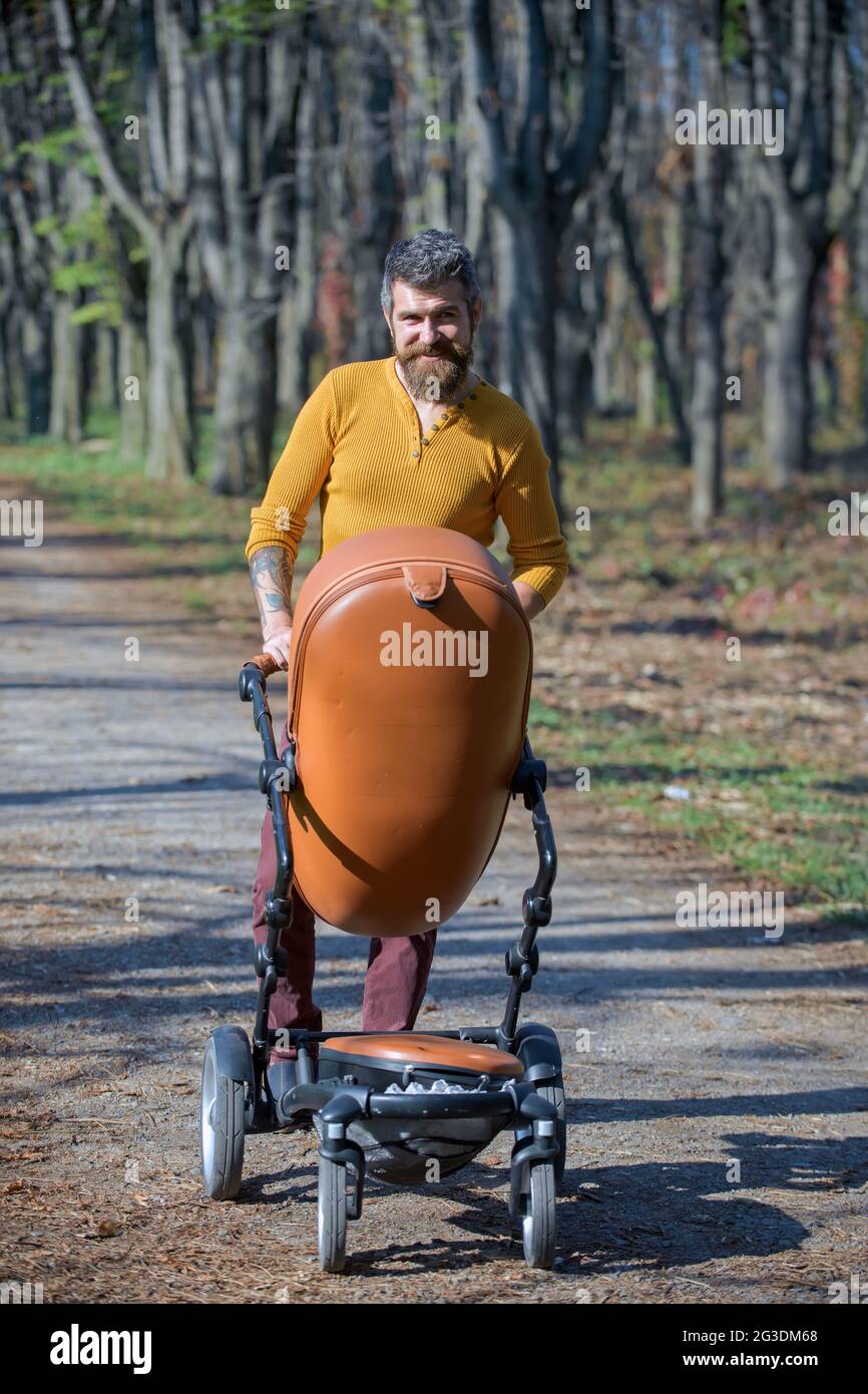 Fathers day concept. Happy man walk baby pram in autumn park on fathers day. The best father ever Stock Photo