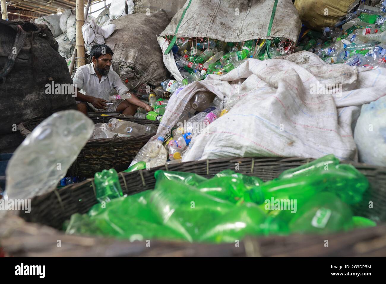 Dhaka, Bangladesh, June 15, 2021. A Bangladeshi worker works in a plastic bottle recycling