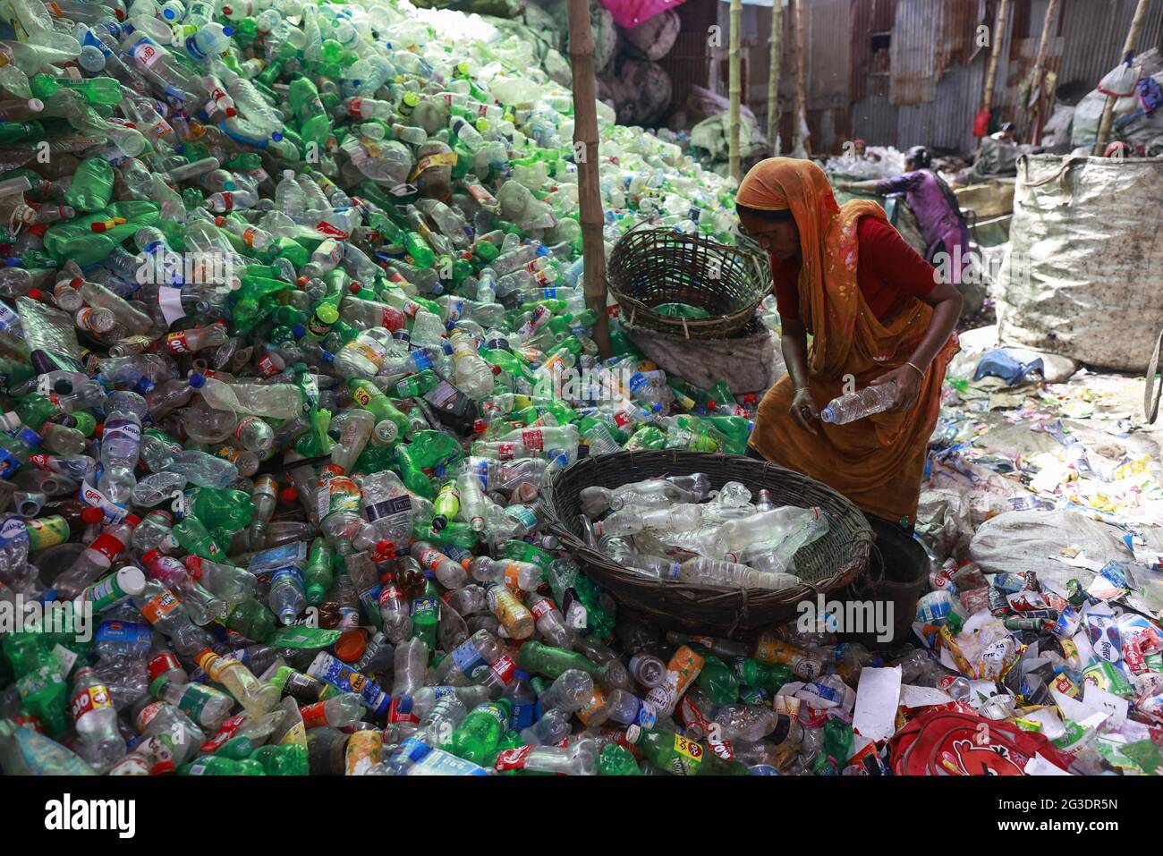 Dhaka, Bangladesh, June 15, 2021. A Bangladeshi worker works in a plastic bottle recycling