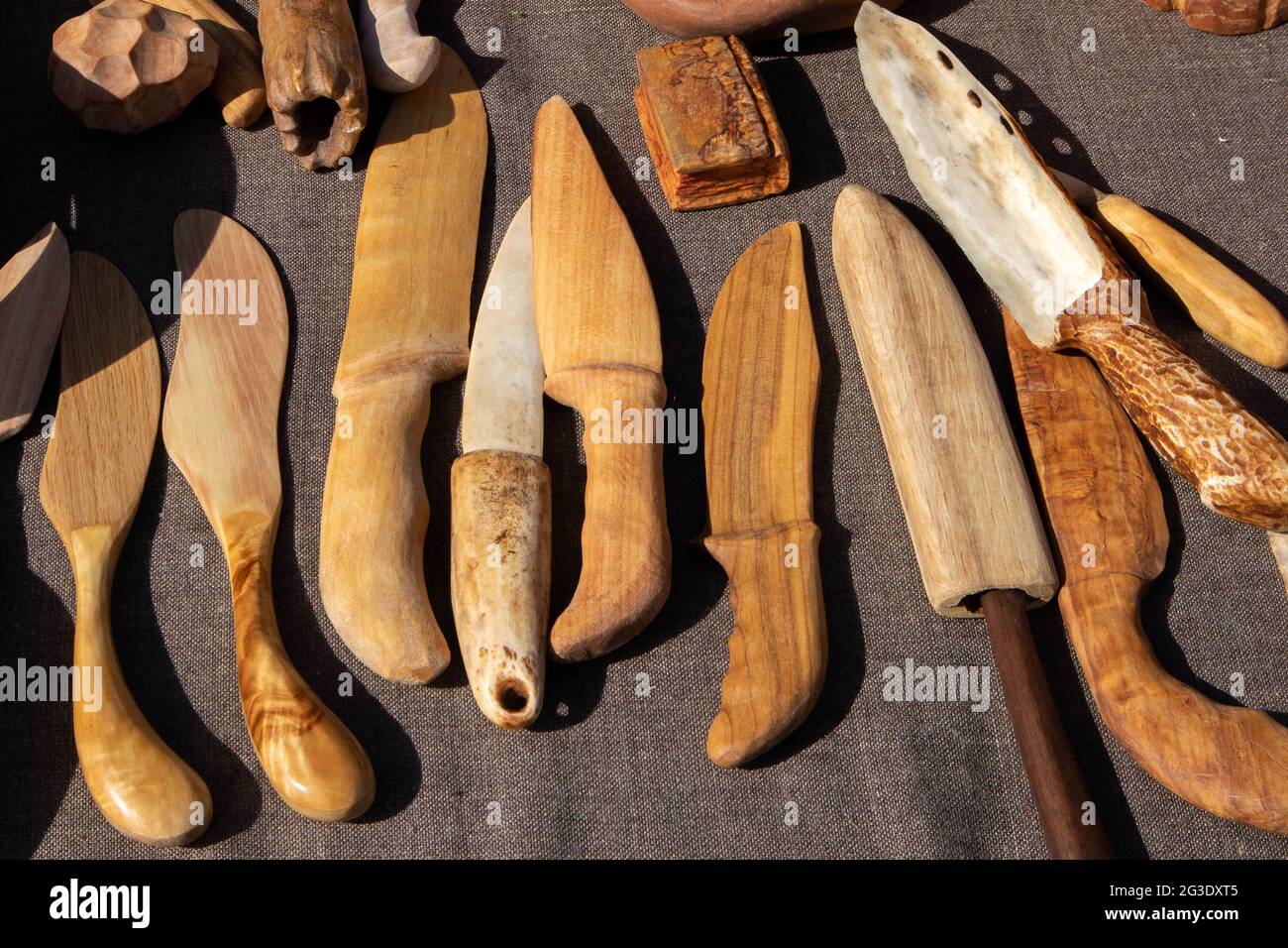 The trade tent with decorative wooden handmade knives at the open air village fair Stock Photo