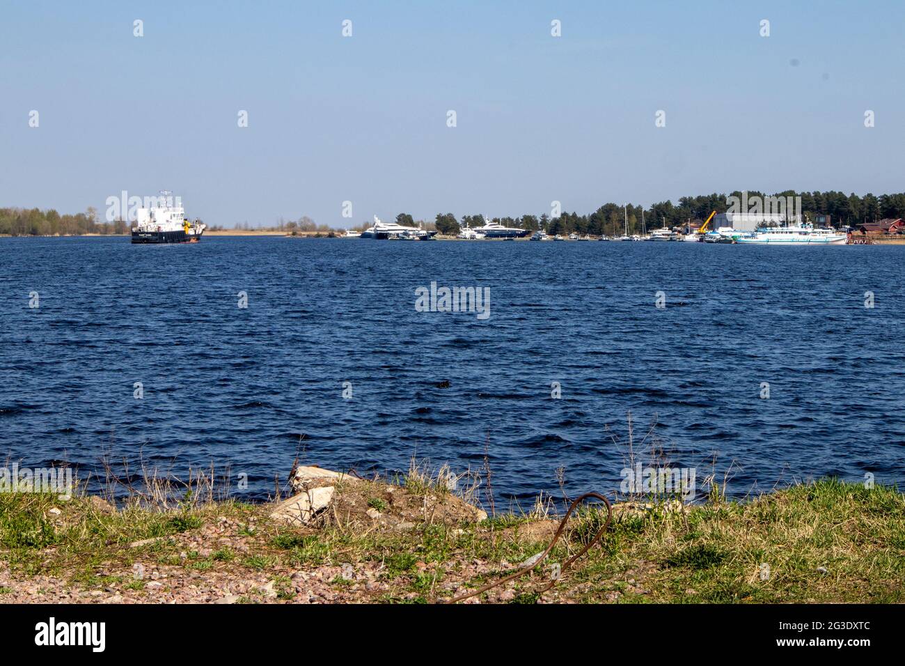 View of the water surface with light waves and pleasure yachts in the distance Stock Photo