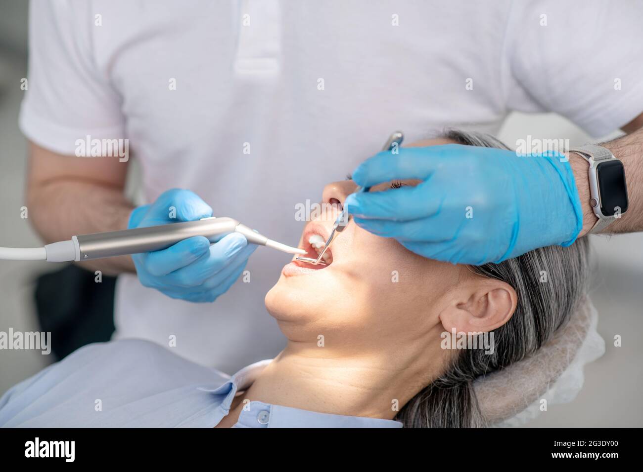Dentist working on patients teeth restoration and making dental