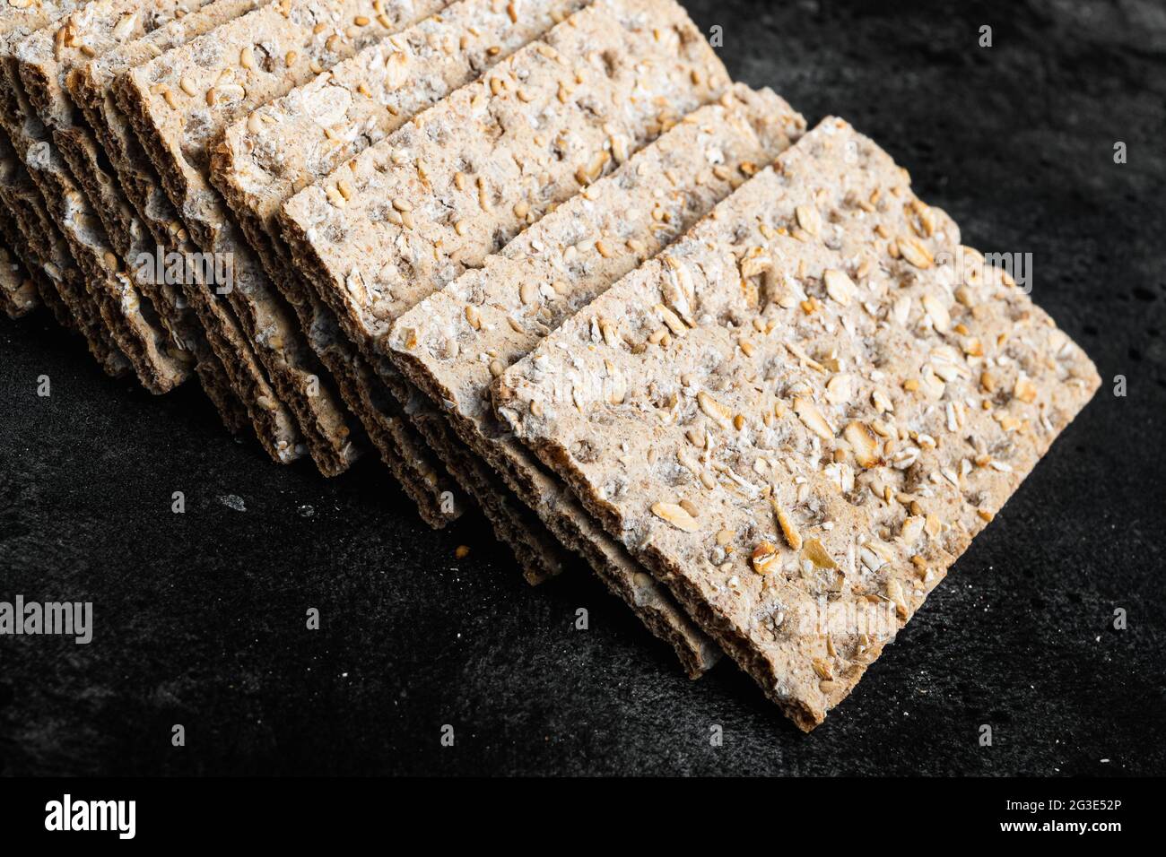 Set of crispy breads set, on black dark stone table background Stock ...