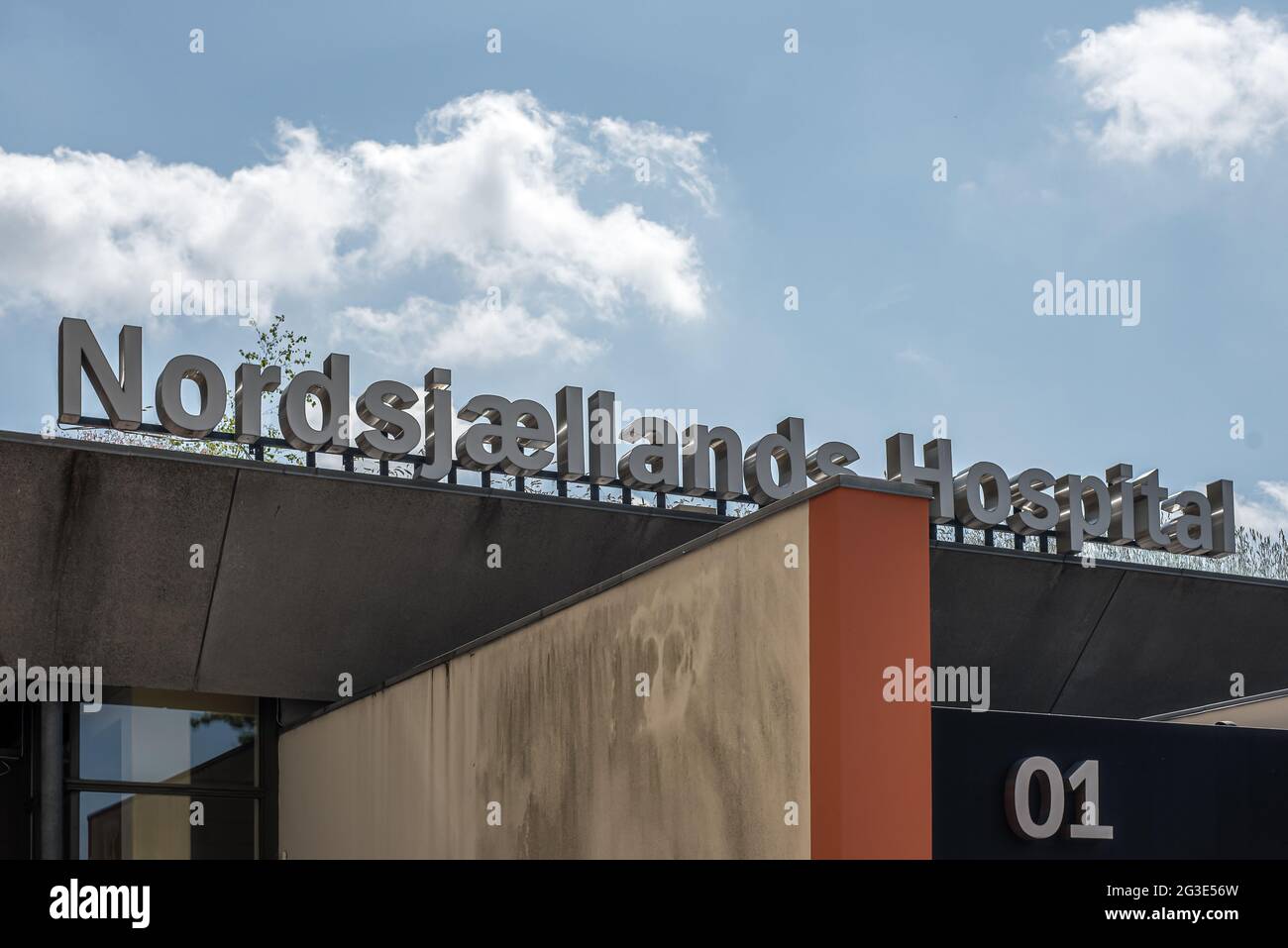 entrance to nordsjællands hospital and the sign against the blue sky, Hillerod, Denmark, June 9, 2021 Stock Photo