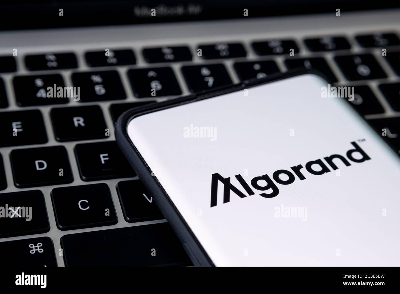 Algorand cryptocurrency platform logo seen on smartphone placed on keyboard of laptop. Concept. Stafford, United Kingdom, June 16, 2021. Stock Photo