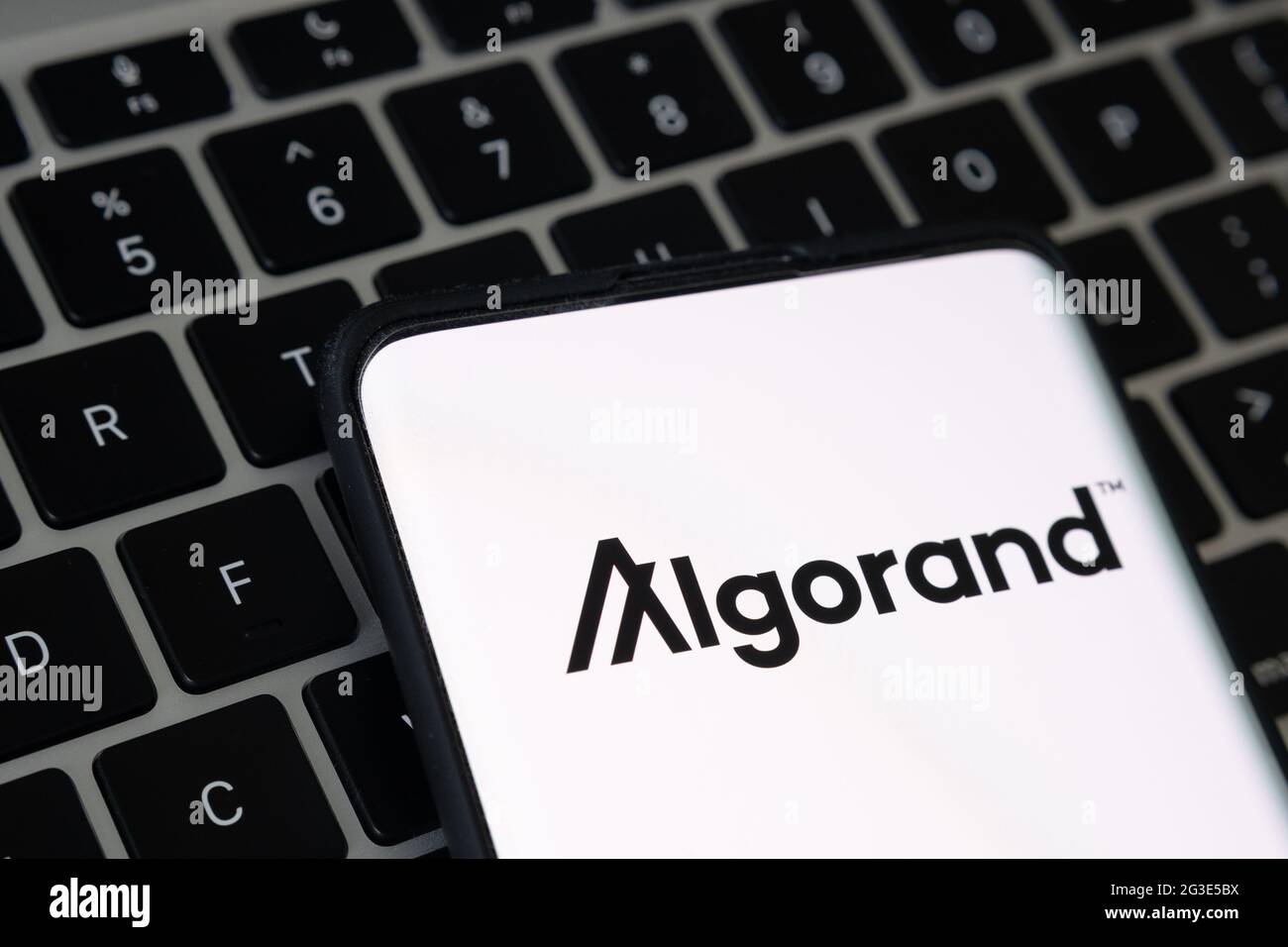 Algorand cryptocurrency platform logo seen on smartphone placed on keyboard of laptop. Concept. Stafford, United Kingdom, June 16, 2021. Stock Photo